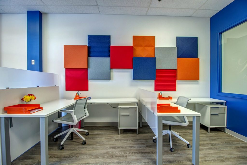 Office setting with colorful acoustical panels on the wall